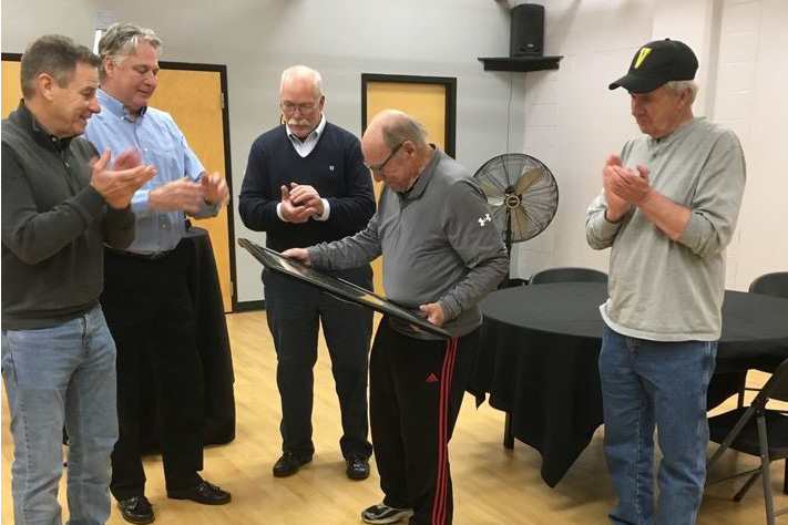 This image is of, left to right, Bob Sneeden ’75, Joe Schrotz ’73, Dave Drews ’76, and Bill Crawford ’75 were among alumni rowers who gathered Dec. 5 to honor their former rowing coach Bill Austin (foreground).