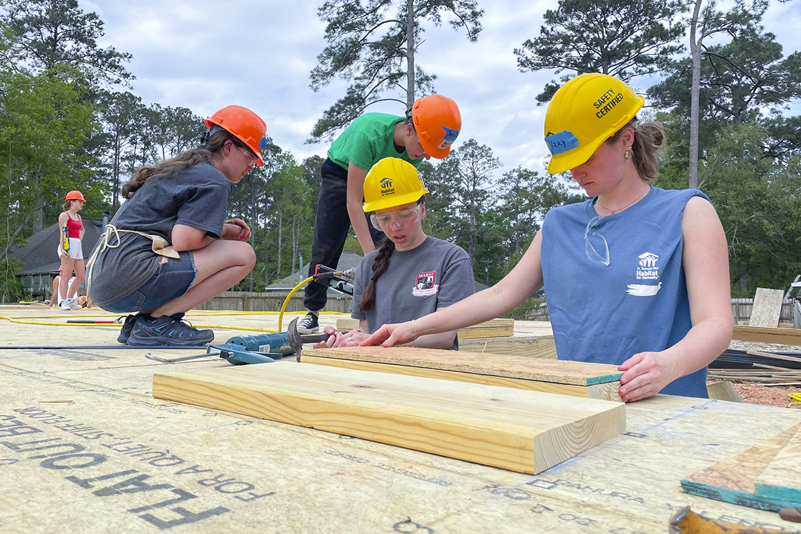 An image of students helping to build new homes in Louisiana